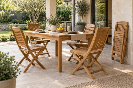 Teak outdoor folding chairs arranged around a patio dining table with one chair folded for storage