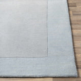 Arkabutla Solid Blue Bordered Wool Rug - Ornate Home
