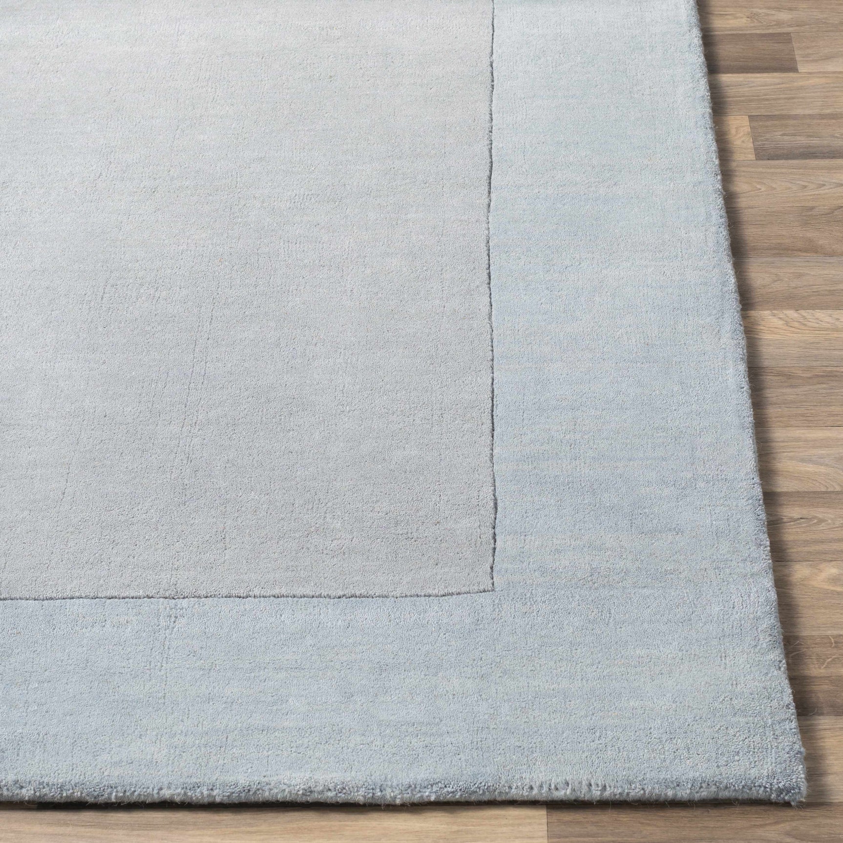 Arkabutla Solid Blue Bordered Wool Rug - Ornate Home
