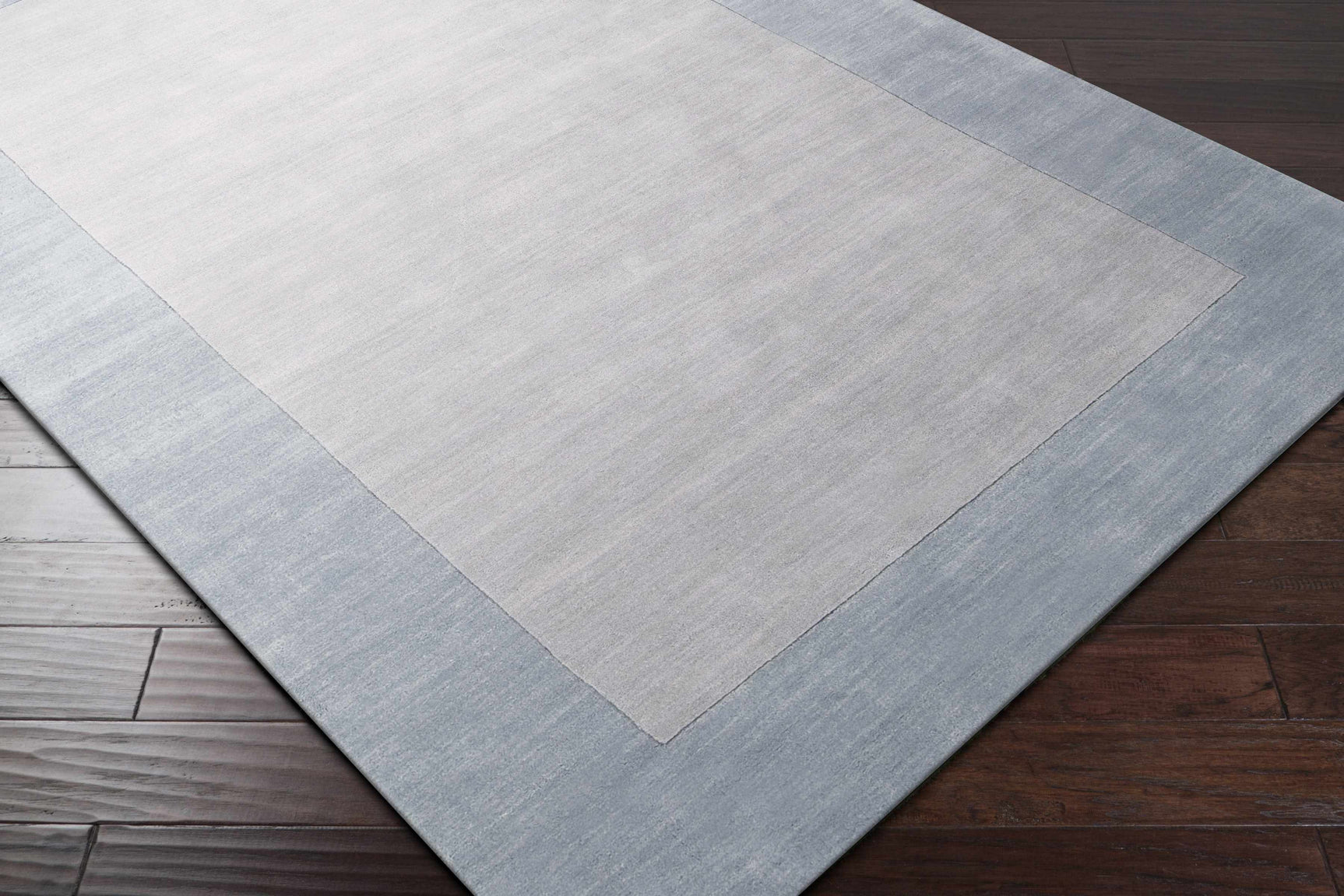 Arkabutla Solid Blue Bordered Wool Rug - Ornate Home