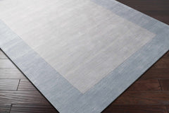 Arkabutla Solid Blue Bordered Wool Rug - Ornate Home