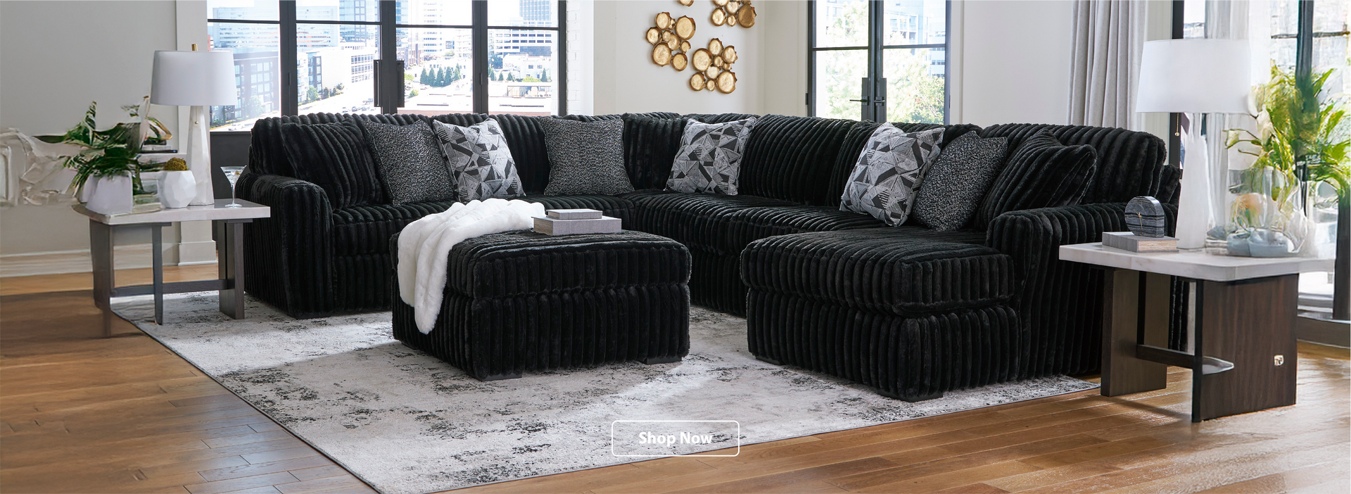 Black sectional sofa in a living room with decor elements.