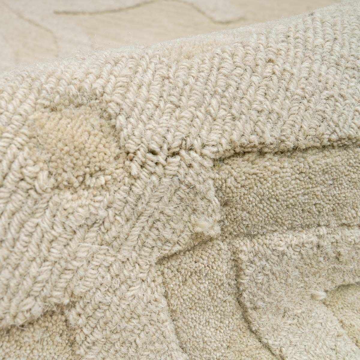 Fyffe Embossed Beige Wool Area Rug - Ornate Home